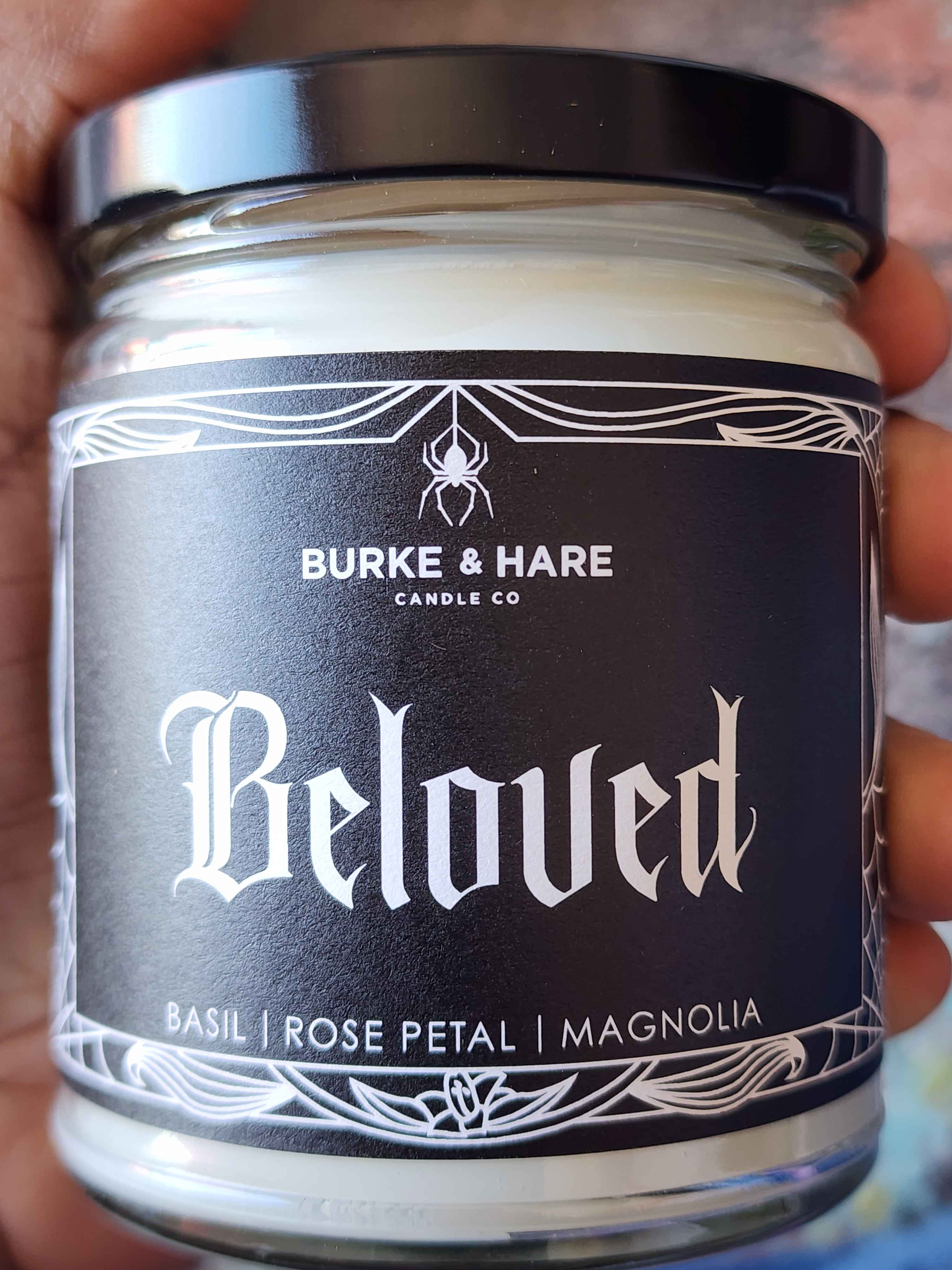 ID: a clear jar candle from Burke & Hare called Beloved, with notes of basil, rose petal, and magnolia