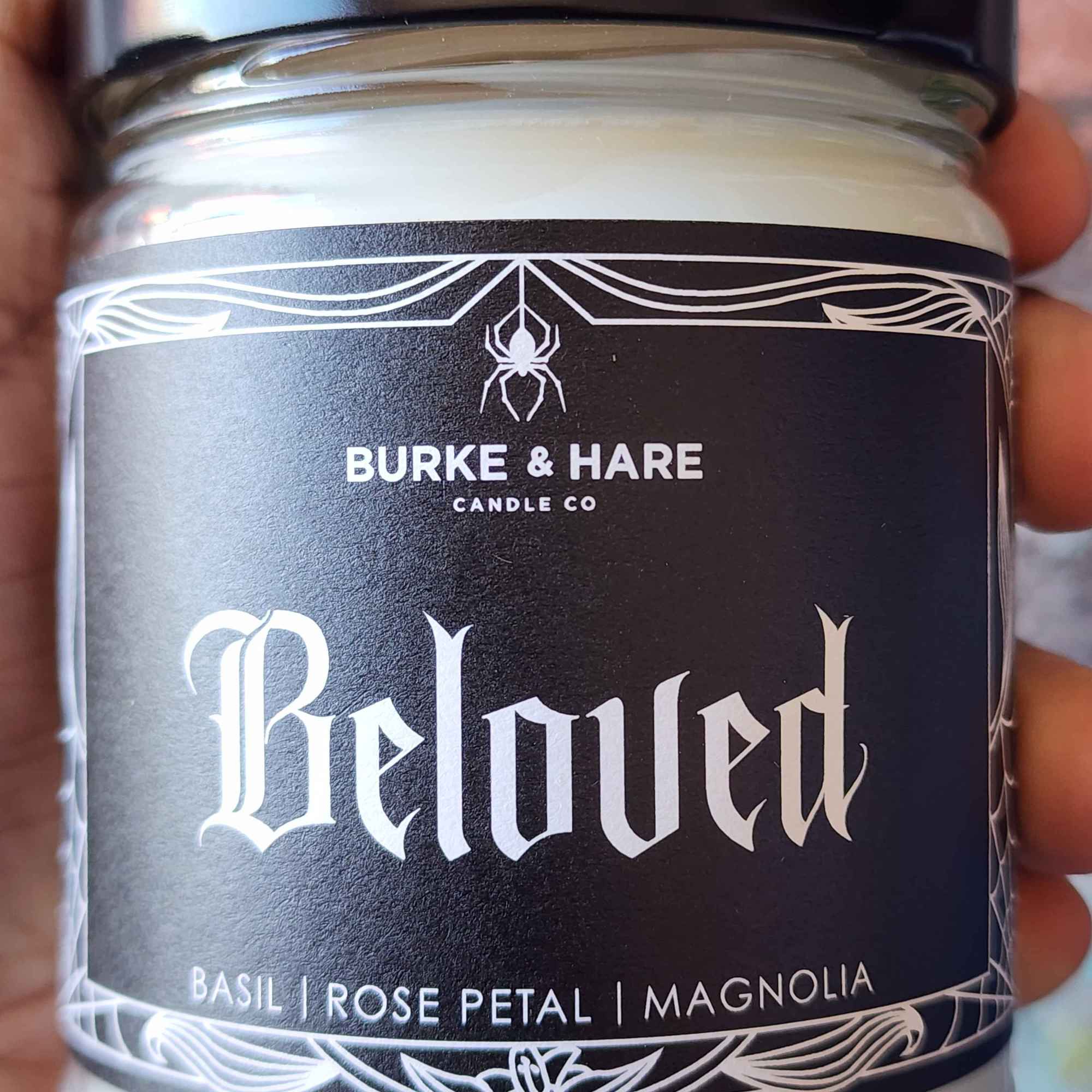 ID: a clear jar candle from Burke & Hare called Beloved, with notes of basil, rose petal, and magnolia