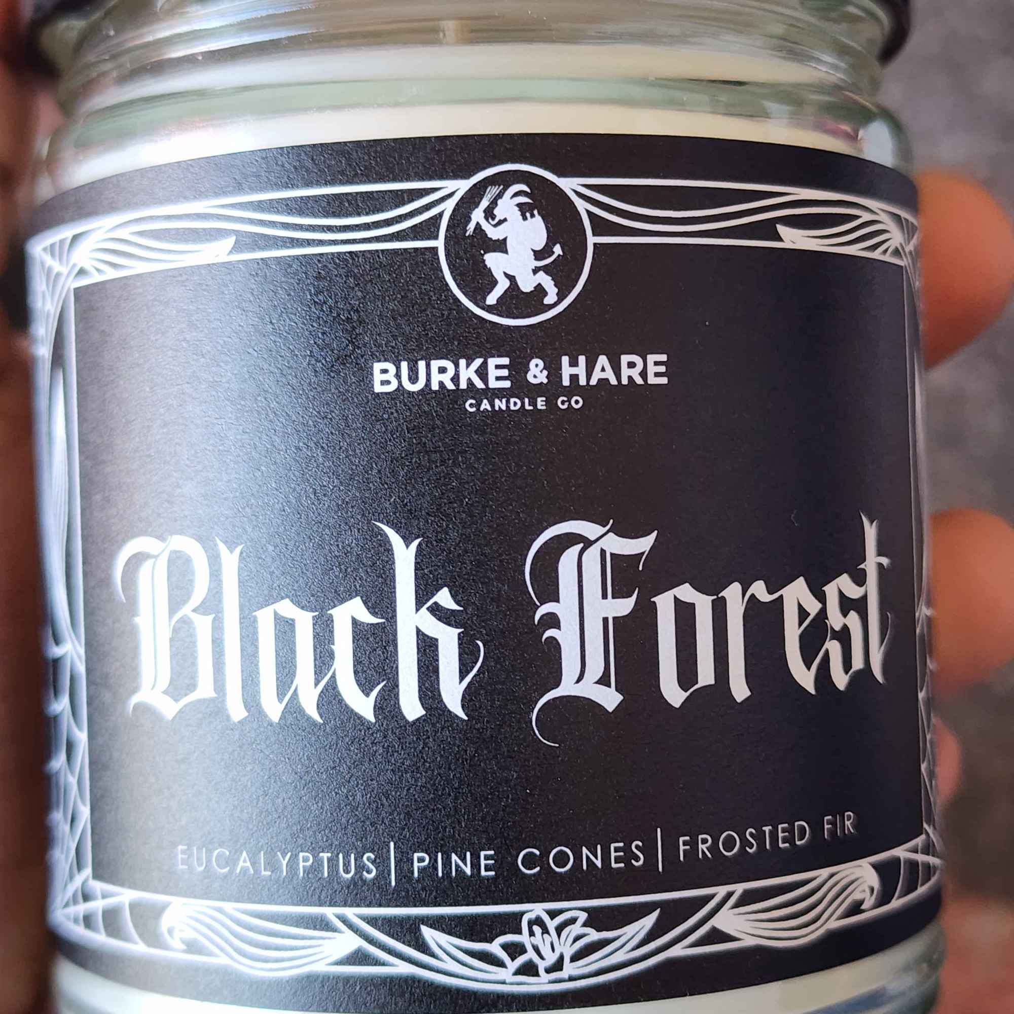 ID: a clear jar candle from Burke & Hare called Black Forest, with notes of eucalyptus, pine cones, and frosted fir