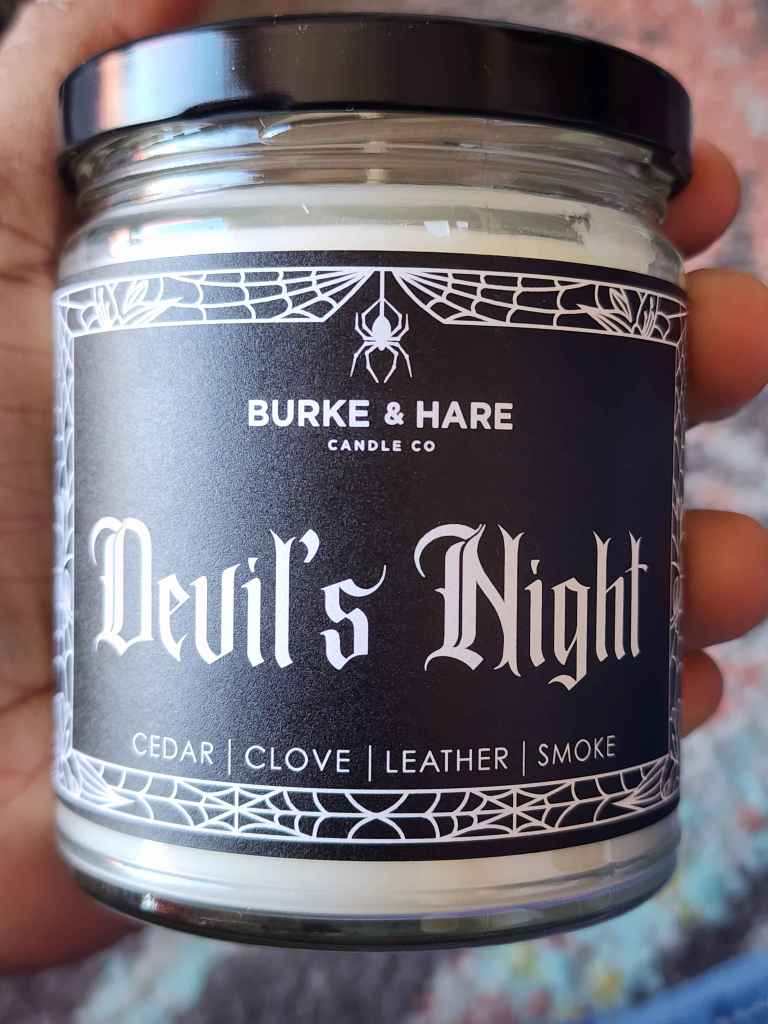 ID: a clear jar candle from Burke & Hare called Devil's Night. it has notes of cedar, clove, leather, and smoke
