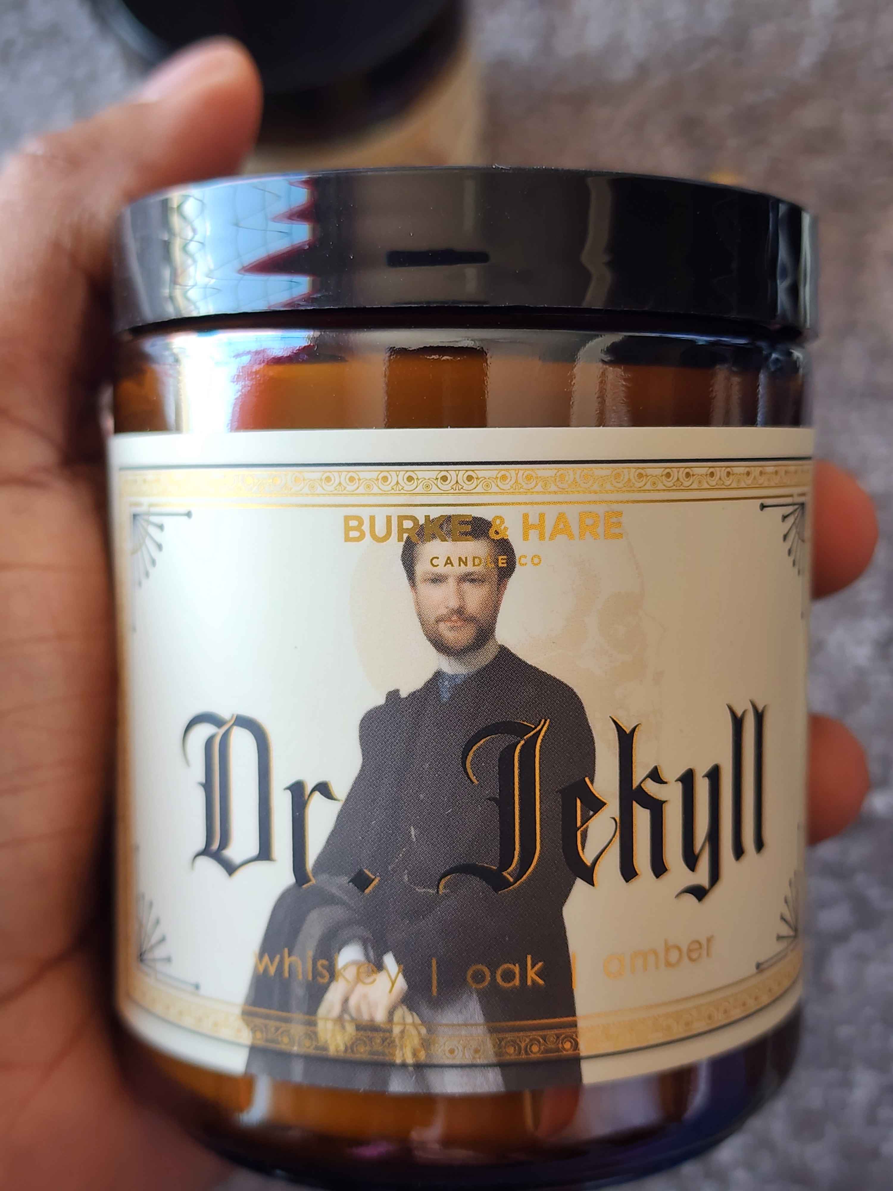ID: an amber jar candle from Burke & Hare called Dr. Jekyll, with notes of whiskey, oak, and amber