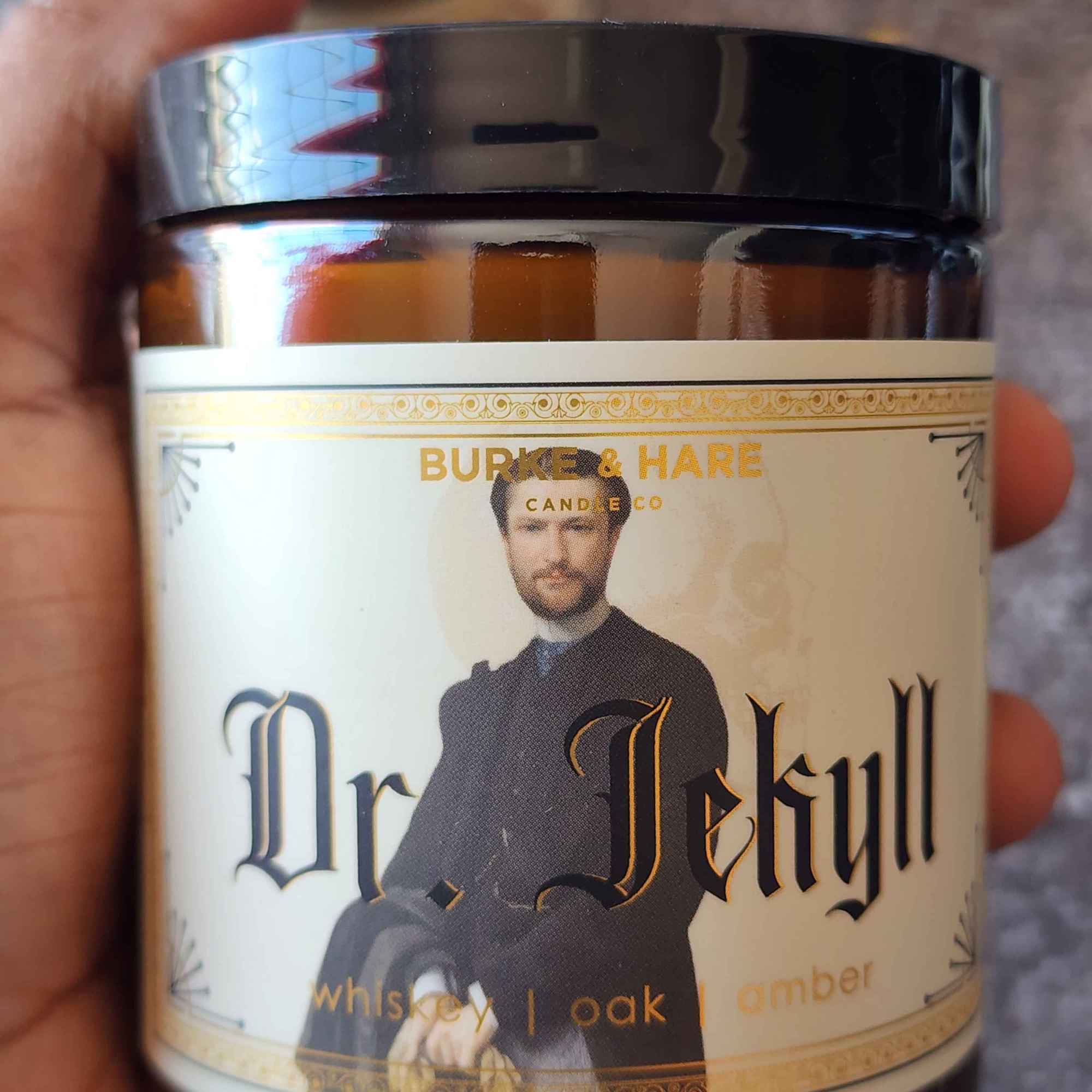 ID: an amber jar candle from Burke & Hare called Dr. Jekyll, with notes of whiskey, oak, and amber