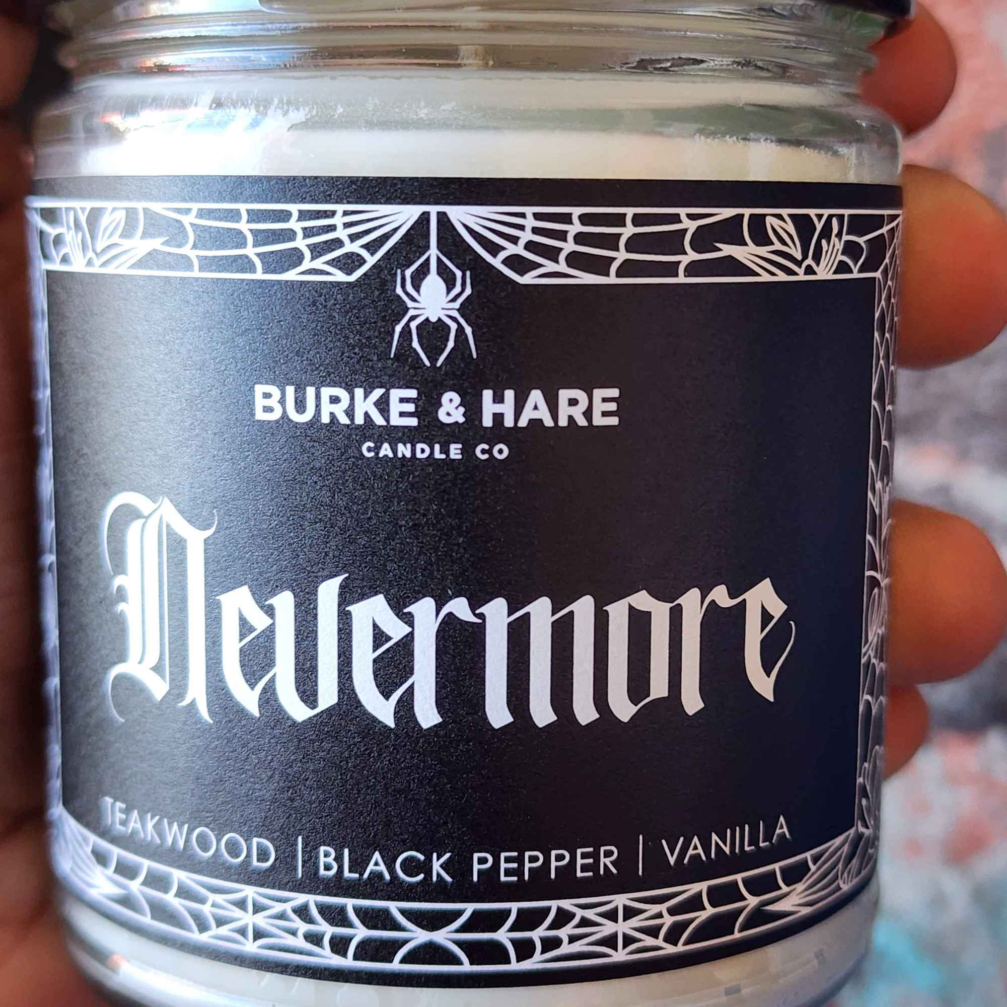 ID: a clear jar candle from Burke & Hare called Nevermore, with notes of teakwood, black pepper, and vanilla