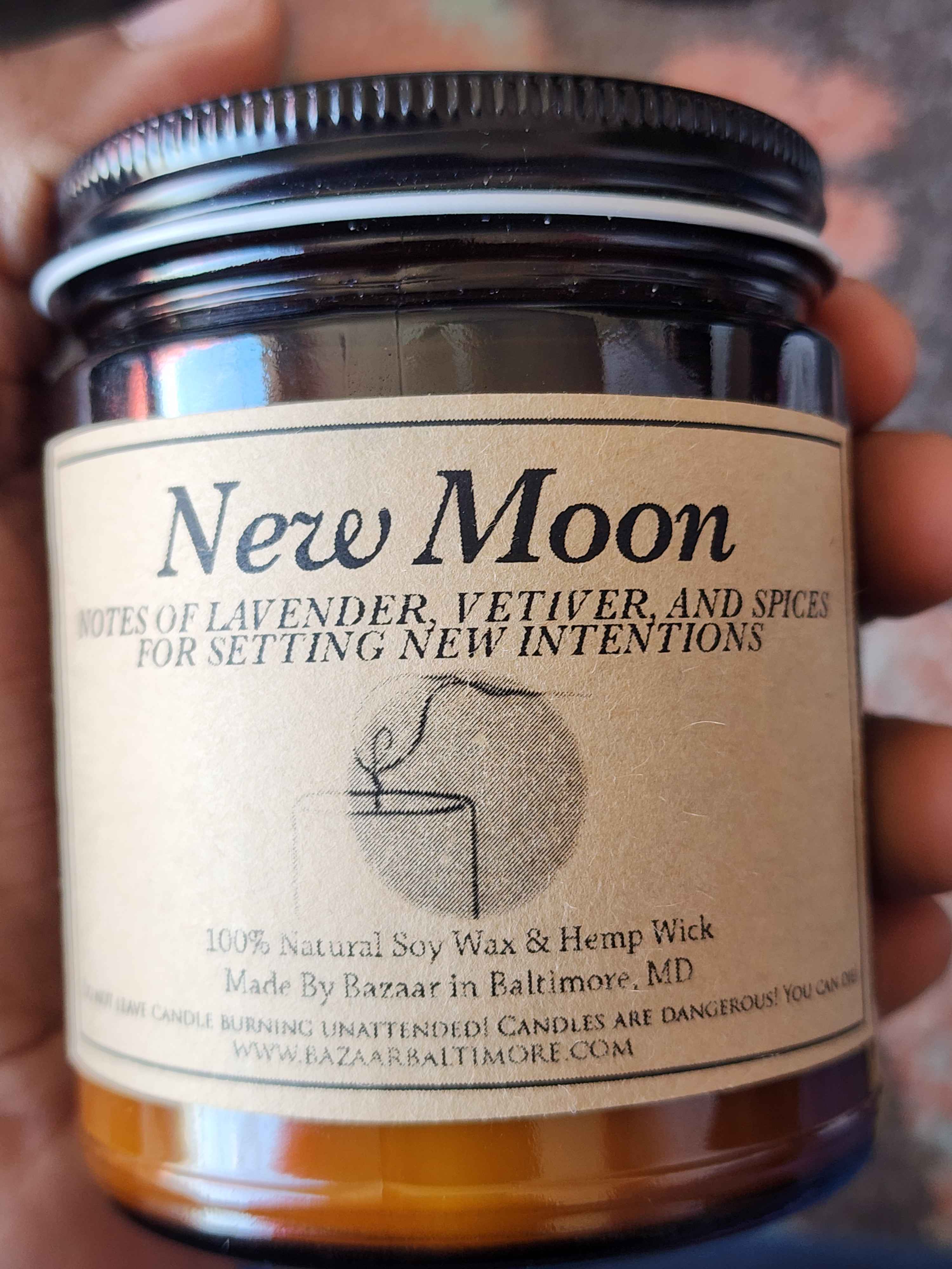 ID: an amber jar candle from Bazaar in Baltimore called New Moon. it has notes of lavender, vetiver, and spices for setting new intentions