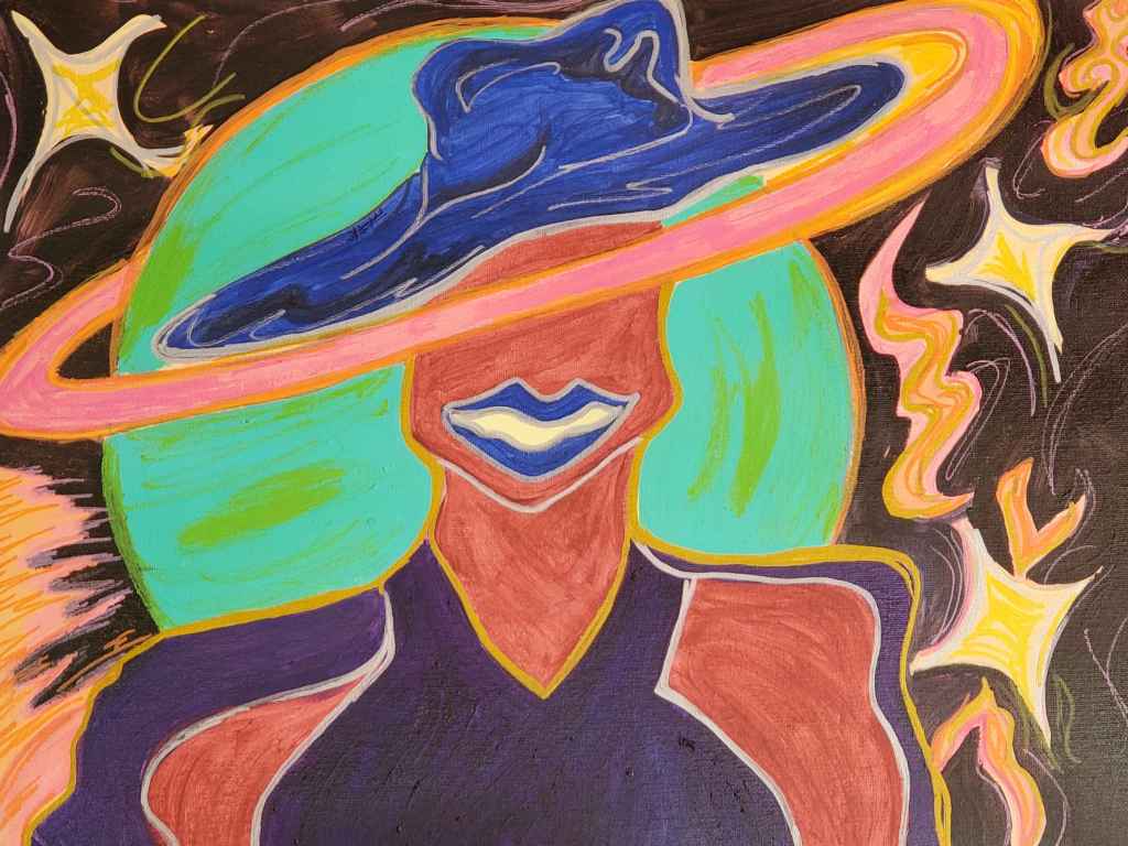 ID: A brown figure in an indigo halter top and matching cape wears a royal blue hat, slanted at an angle; the figure and their clothing are outlined in silver and gold. Their mouth is parted in a grin, and their lipstick matches their hat. In the background, a teal planet swirls in a black sky with sparkling pink and yellow stars. The planet’s pink-orange ring covers the figure’s eyes.